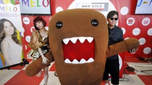 Pop singer and model Yun*chi  and DJ Taku Takahashi of m-flo with Domo, NHK World’s mascot, at Waku Waku +NYC in Brooklyn, Aug. 2015. The performers are frequent guests of NHK World’s pop music TV show J-MELO, Japan’s only music program recorded entirely in English. (Jason DeCrow/AP Images for NHK WORLD TV)