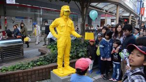 yellow man on street and crowd